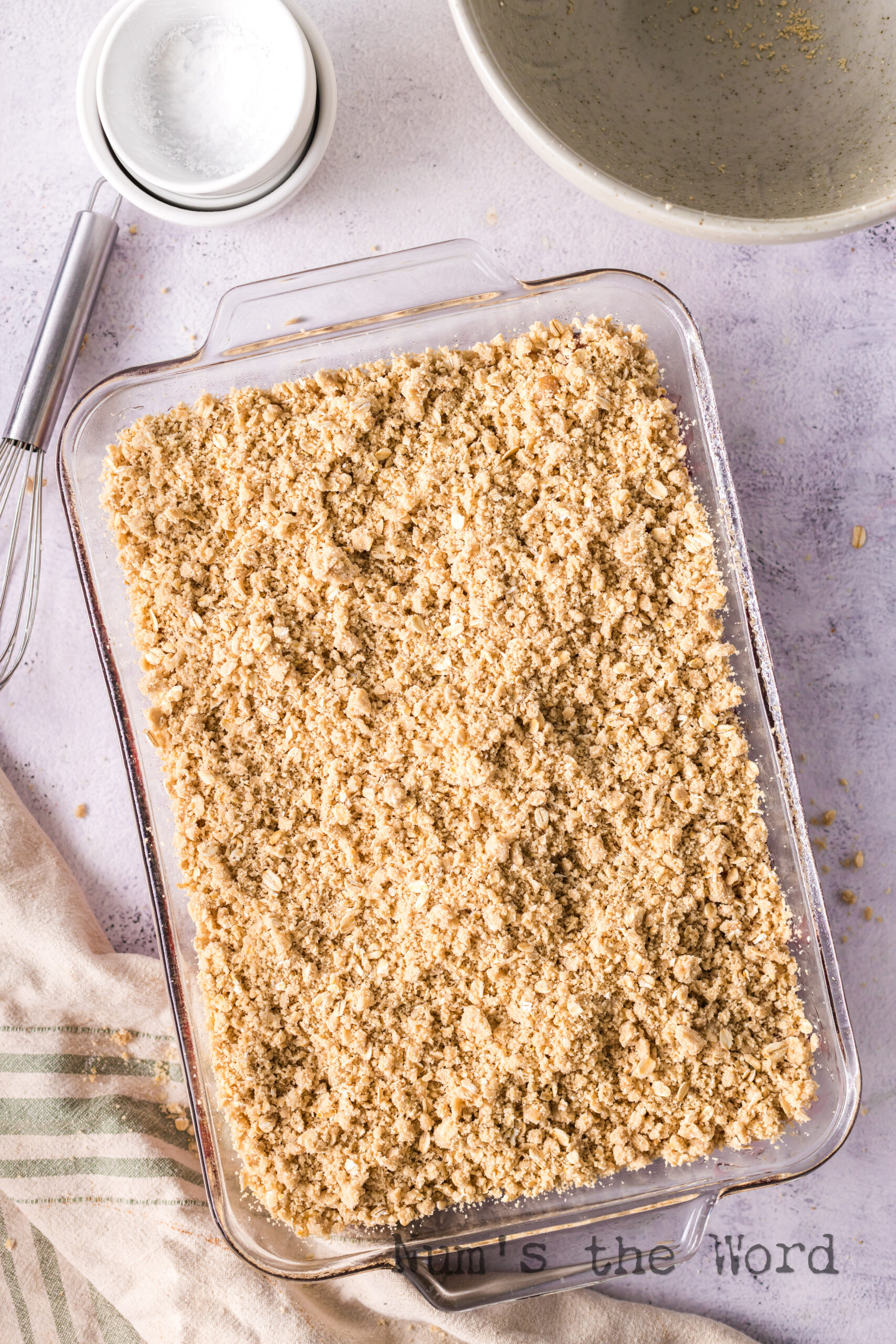 Crumble mixture spread out on top of the cherry rhubarb mixture.