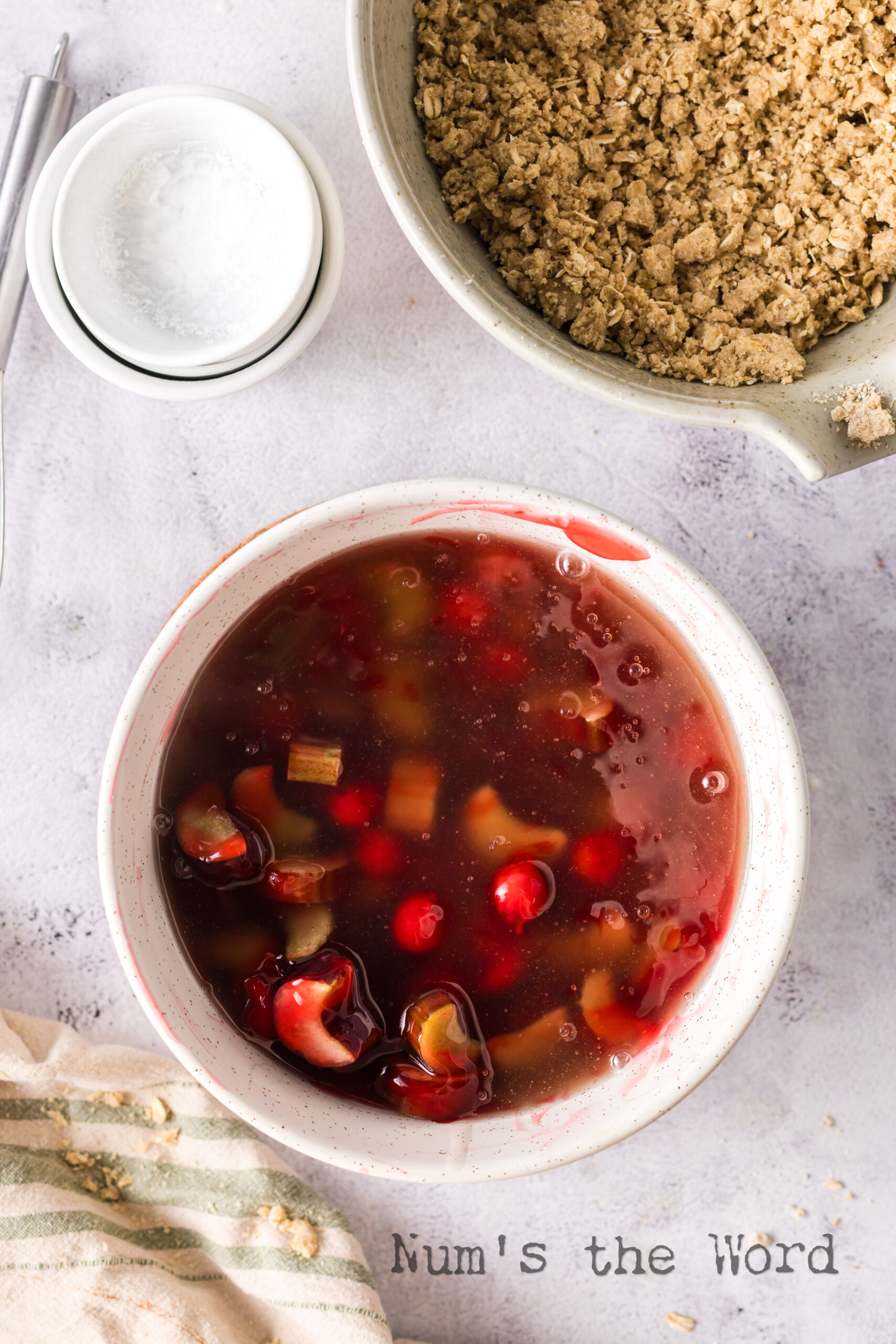 rhubarb crisp with thickened corn starch mixture mixed together in a bowl.