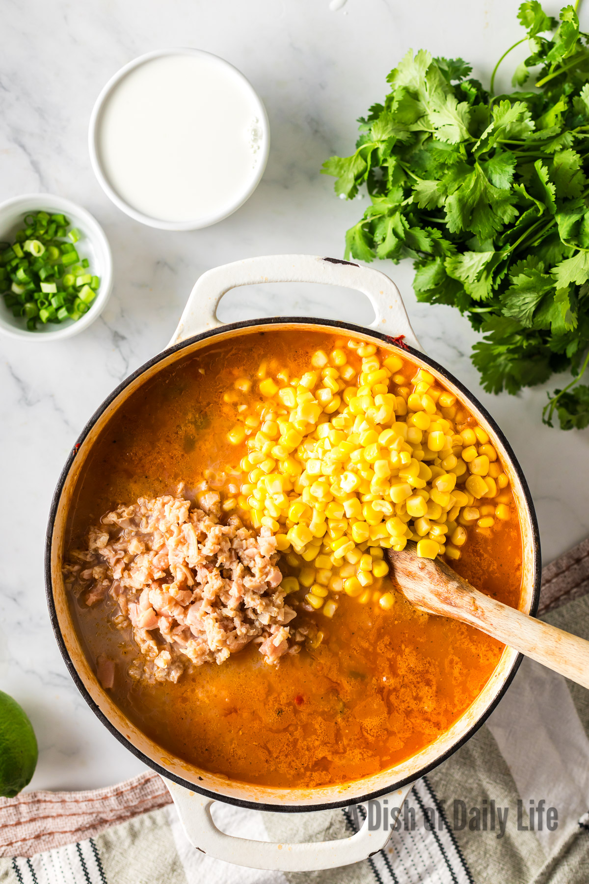 Clams and corn added to soup pot.